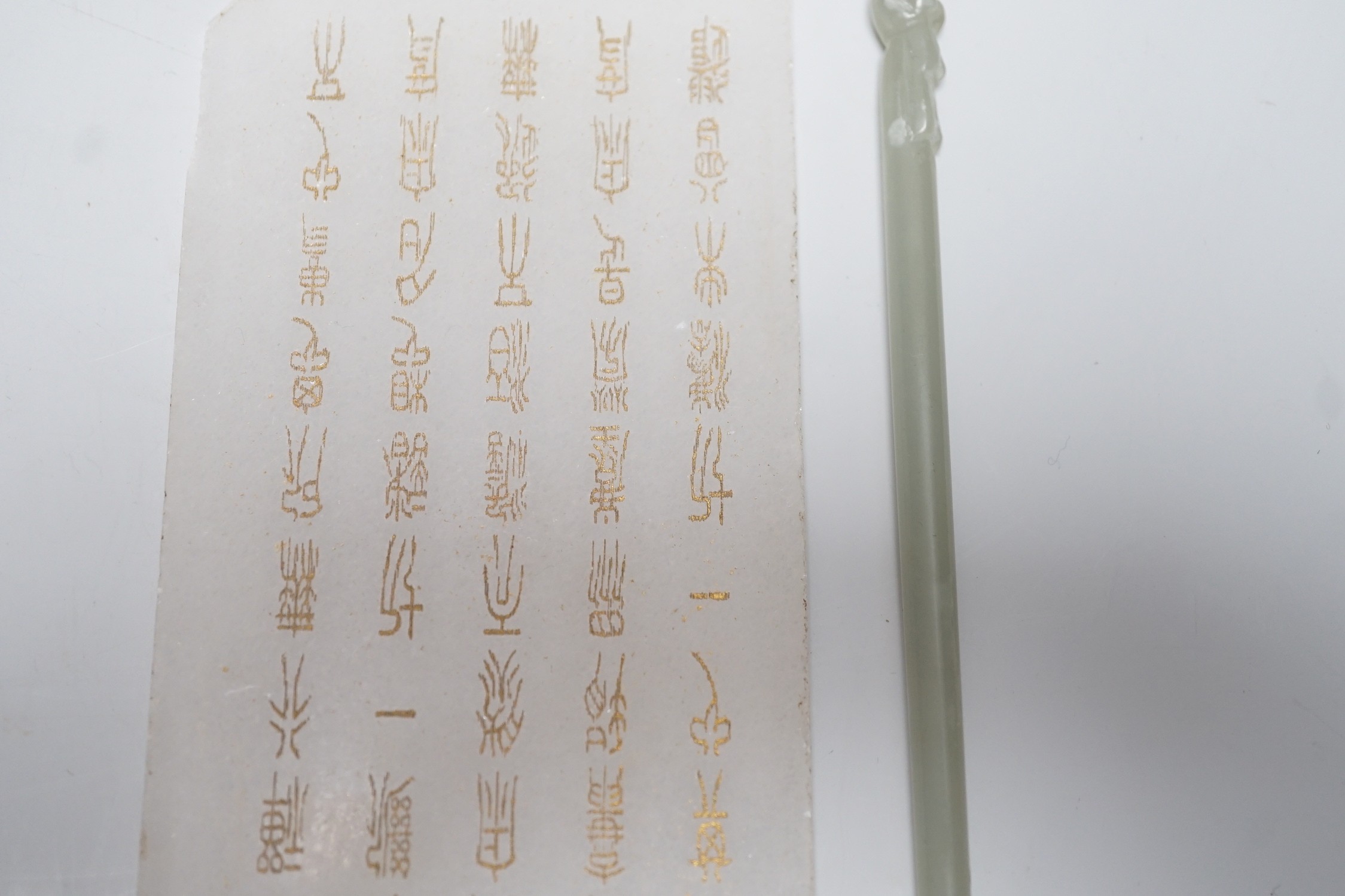 A Chinese carved stone tablet, 15.5 x 7.8 cm and a hair pin
